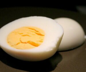 Hard boiled egg on brown plate