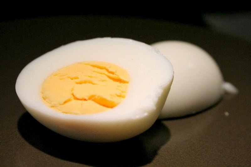 Hard boiled egg on brown plate