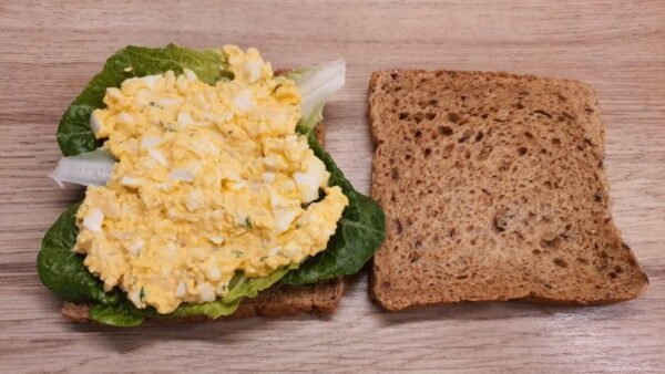Preparing egg salad sandwich