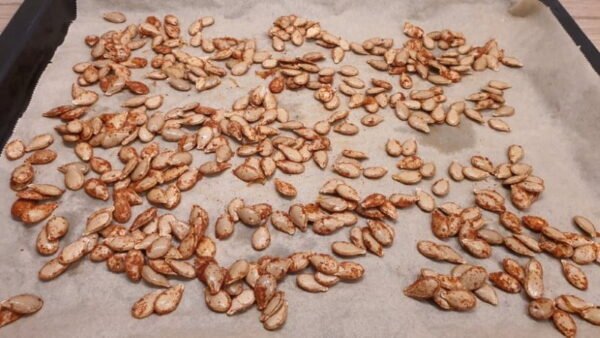 Pumpkin seeds with spices on baking tray