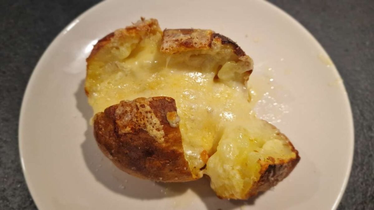 Baked Potatoes with Melted Cheese on a Plate