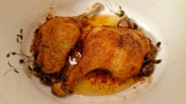 Roasted duck legs in a dish