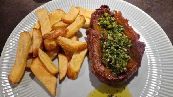 Chimichurri spooned over a sirloin steak