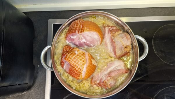 Smoked meats simmering with the sauerkraut