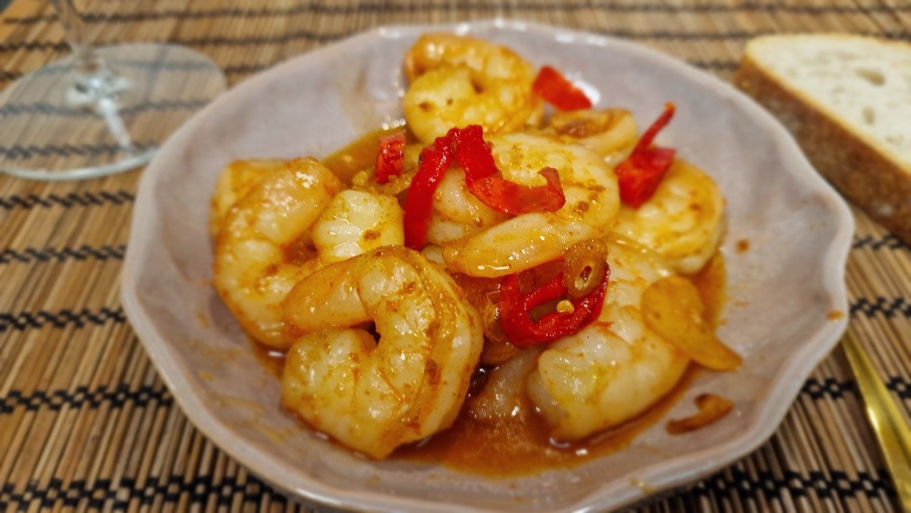 Close-up of gambas pil pil with shrimp in garlic-and-paprika oil