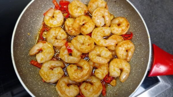 Overhead view of gambas pil pil in a skillet