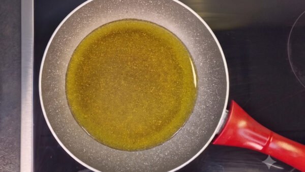 Extra-virgin olive oil heating in a skillet