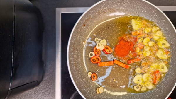 Paprika stirred into the garlic-and-chili oil