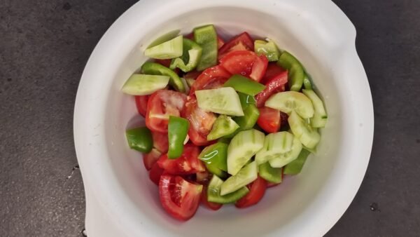 Vegetables, vinegar, and olive oil ready to be blended for gazpacho