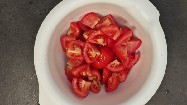 Ripe tomato chunks added to the soaked bread