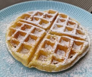Belgian waffle dusted with powdered sugar