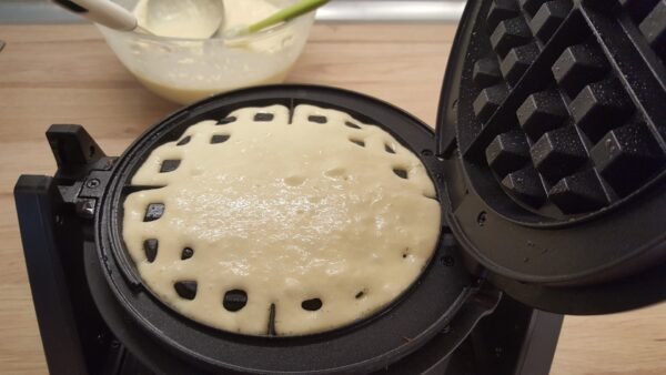 Waffles cooking in a waffle iron