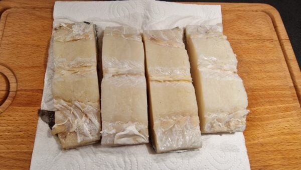 Patting salt cod dry