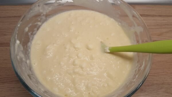 Folding beaten egg whites into waffle batter