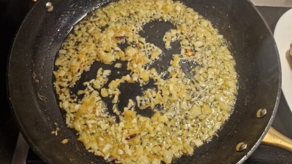 Onion and garlic sautéing in the pan