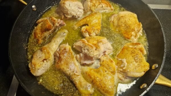 Chicken cooking with the lemon sauce ingredients