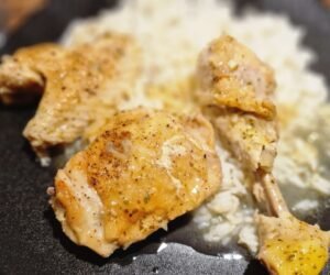 Greek lemon chicken served with its sauce over rice