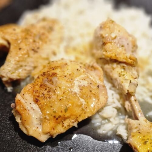 Greek lemon chicken served with its sauce over rice