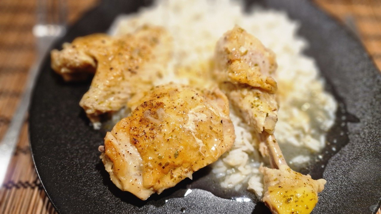 Greek lemon chicken served with its sauce over rice