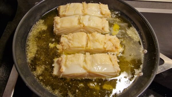 Cod cooking after being turned over