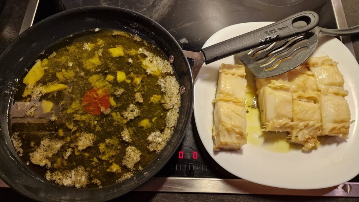Cooked cod transferred from the skillet to a plate