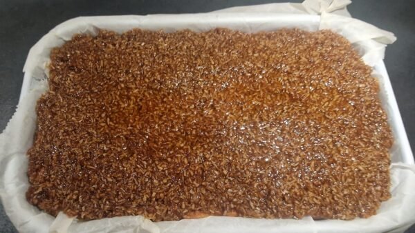 Coconut topping spread over the cake base