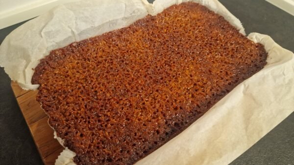 Danish dream cake after the final bake, with a browned coconut topping