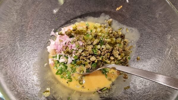 Chopped seasonings mixed into the sauce
