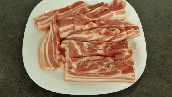 Sliced fresh, skin-on pork belly
